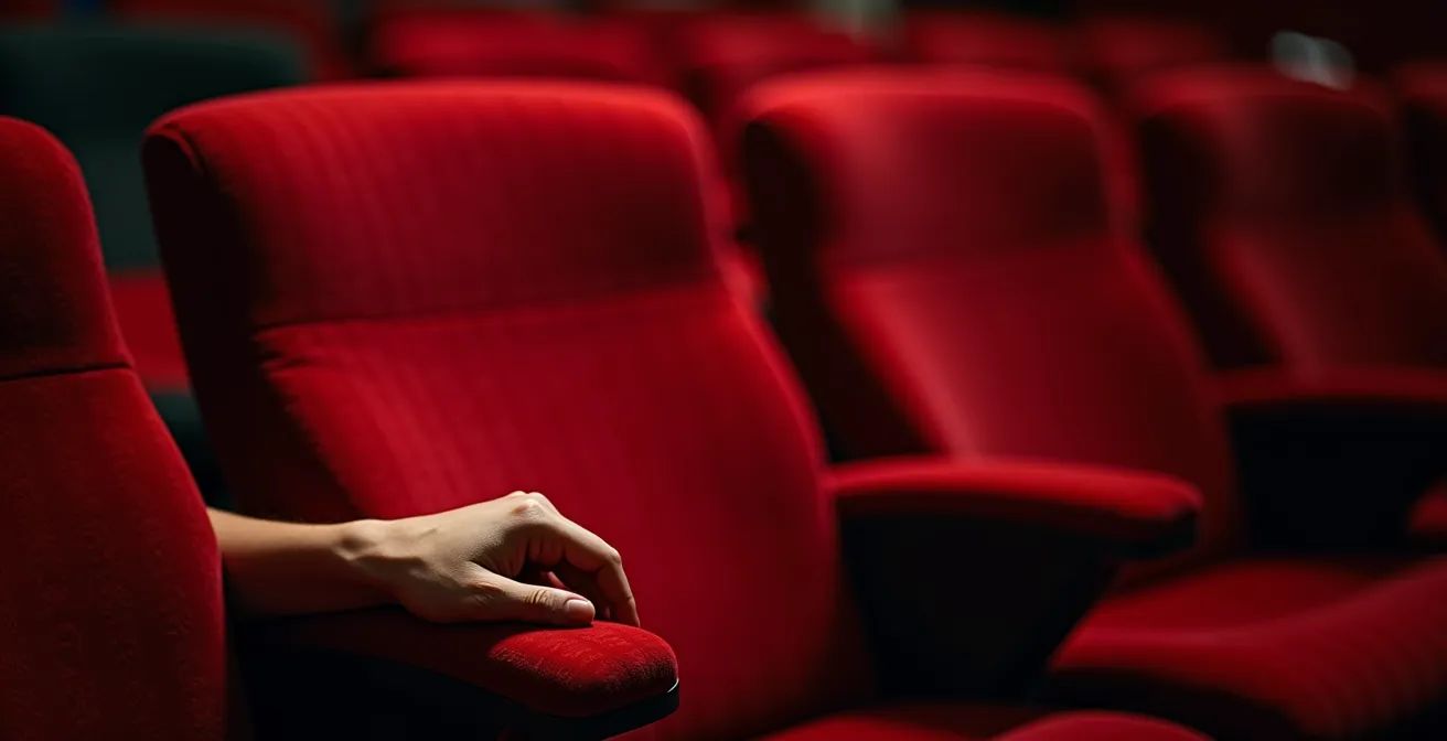 Extreme close-up of theater seat fabric texture with dramatic lighting